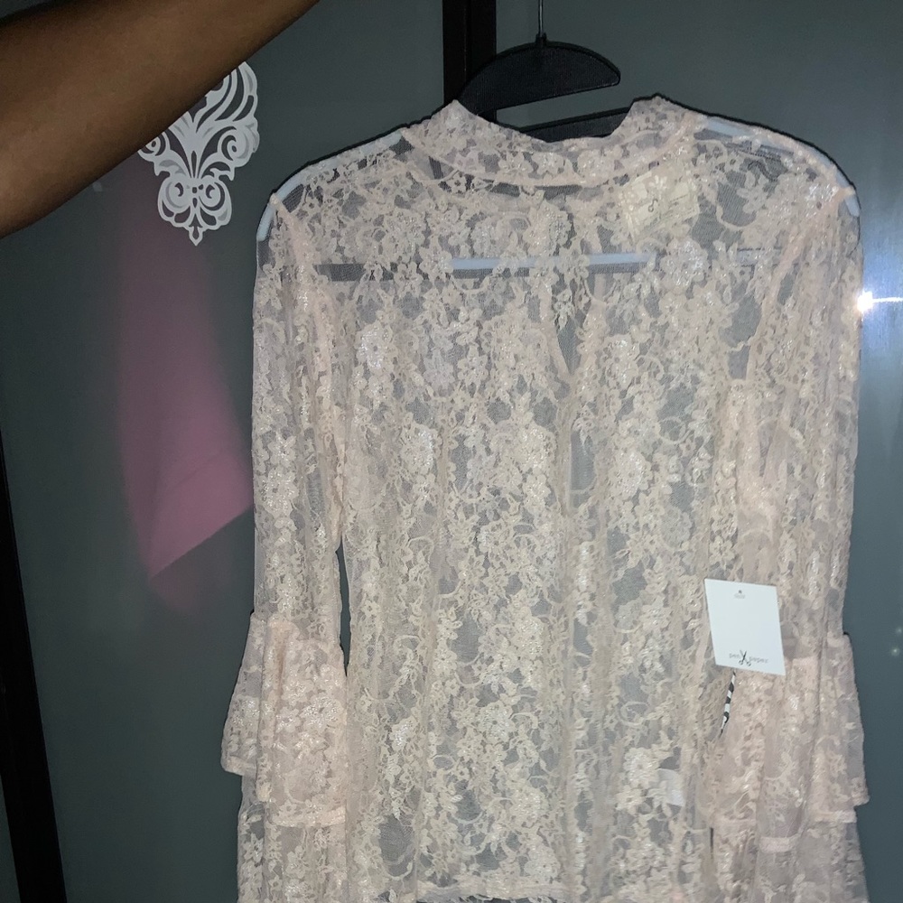 Elegant sheer lace blouse with ruffled sleeves